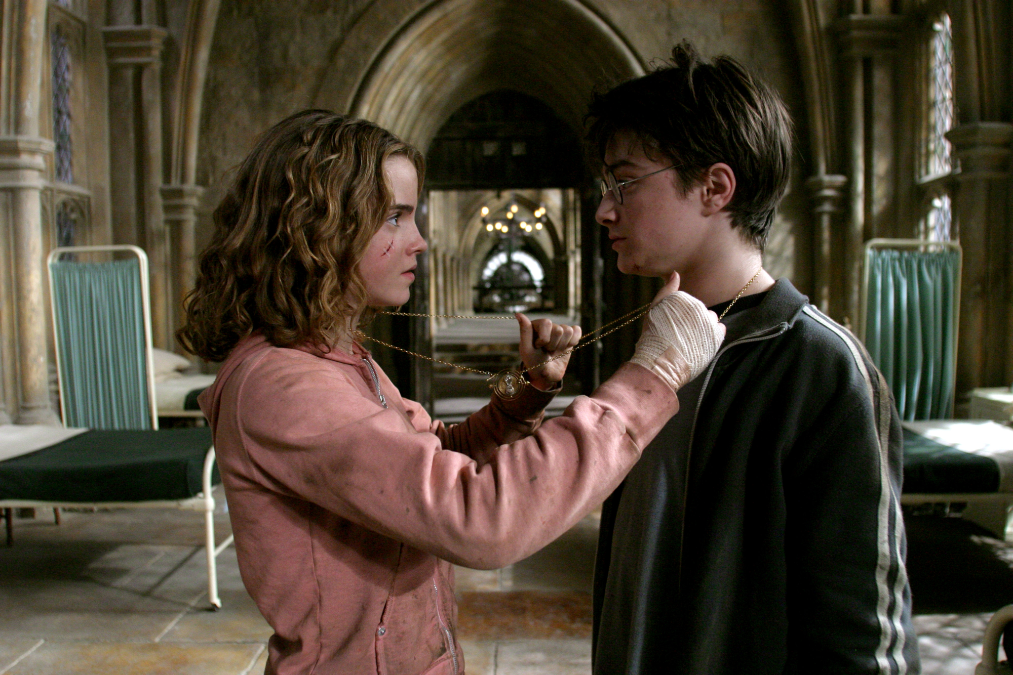 Image of Hermione Grainger and Harry Potter putting on a time-turner so they can go back and save Sirius Black.